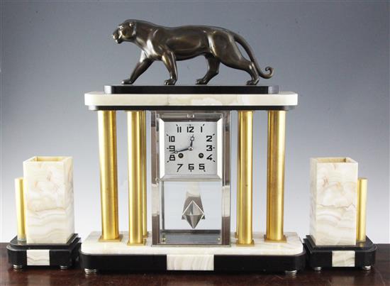 A French Art Deco two colour onyx and marble clock garniture, height 18.5in., vases 8in.